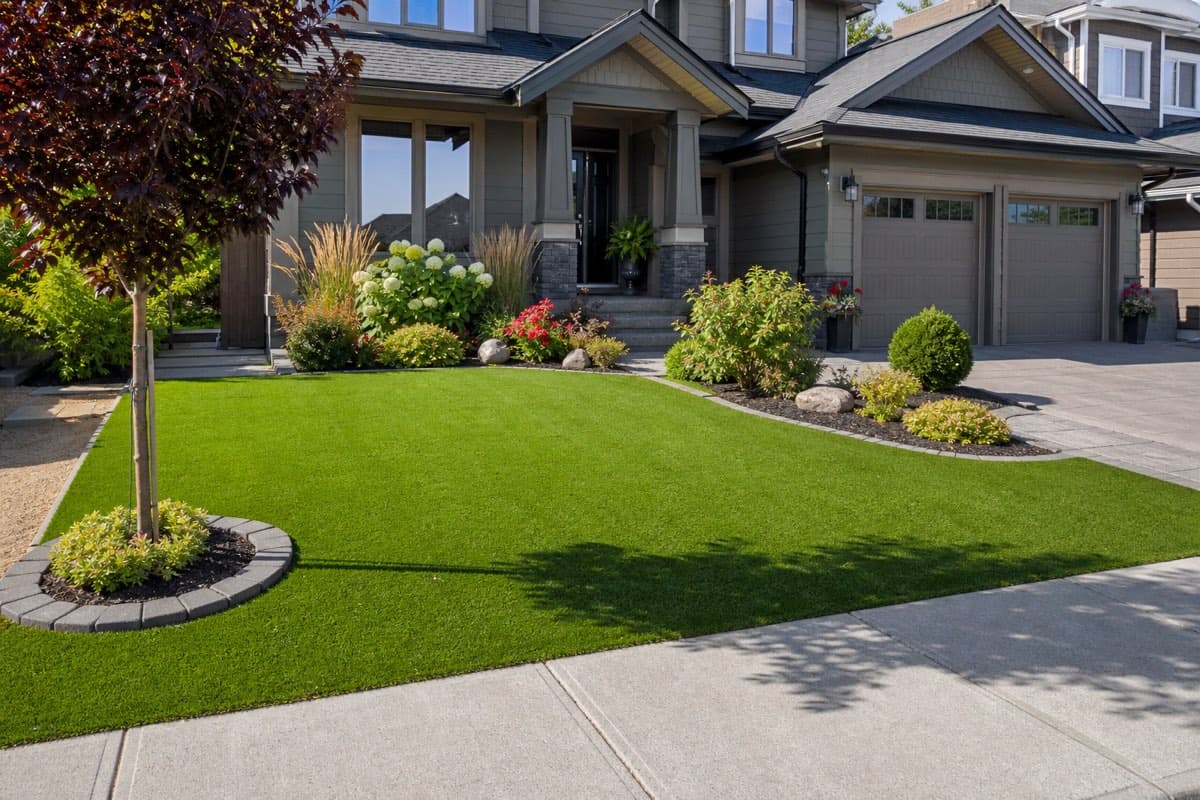 Front yard artificial grass install boosting curb appeal on a Fraser Valley home